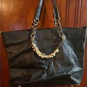 Black leather tote with floral design and pearls with matching wallet